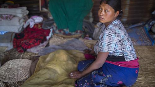 26 year old Mingwa Lama sits in her makeshift tent after loosing her house to the quake. She is eight months pregnant and has a 22 month child in Baruwa.