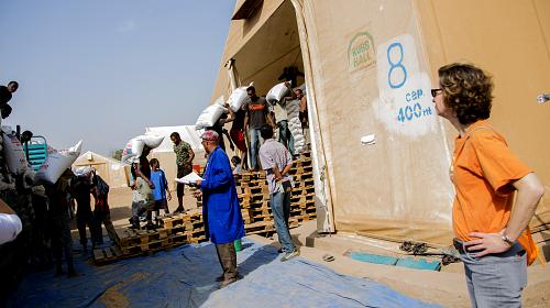 Michelle Nunn, CARE's president and CEO, looks on as food aid arrives at a warehouse in Dire Dawa, Ethiopia. A widespread drought is severely impacting Ethiopia, leaving millions of people without enough to eat. CREDIT: Terhas Borhe/CARE 