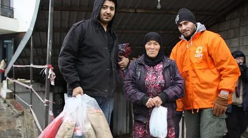 Syria refugees receive blankets from CARE staff to help survive winter. Credit: Johanna Mitscherlich/CARE