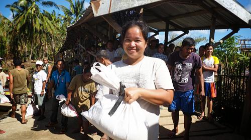 After typhoon Hagupit hit the Philippines, CARE distributed food packs to almost 2,000 families in badly-hit villages in Eastern Samar, in coordination with local partners. Photo by CARE.