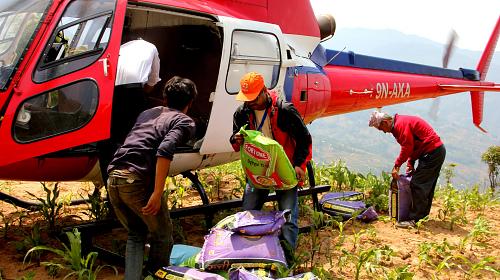 CARE staff unloads 500 kilos of food to distribute to Baruwa, a remote village in Sindhupalchowk. This is the first aid Baruwa has seen as it is only accessible by foot or helicopter.