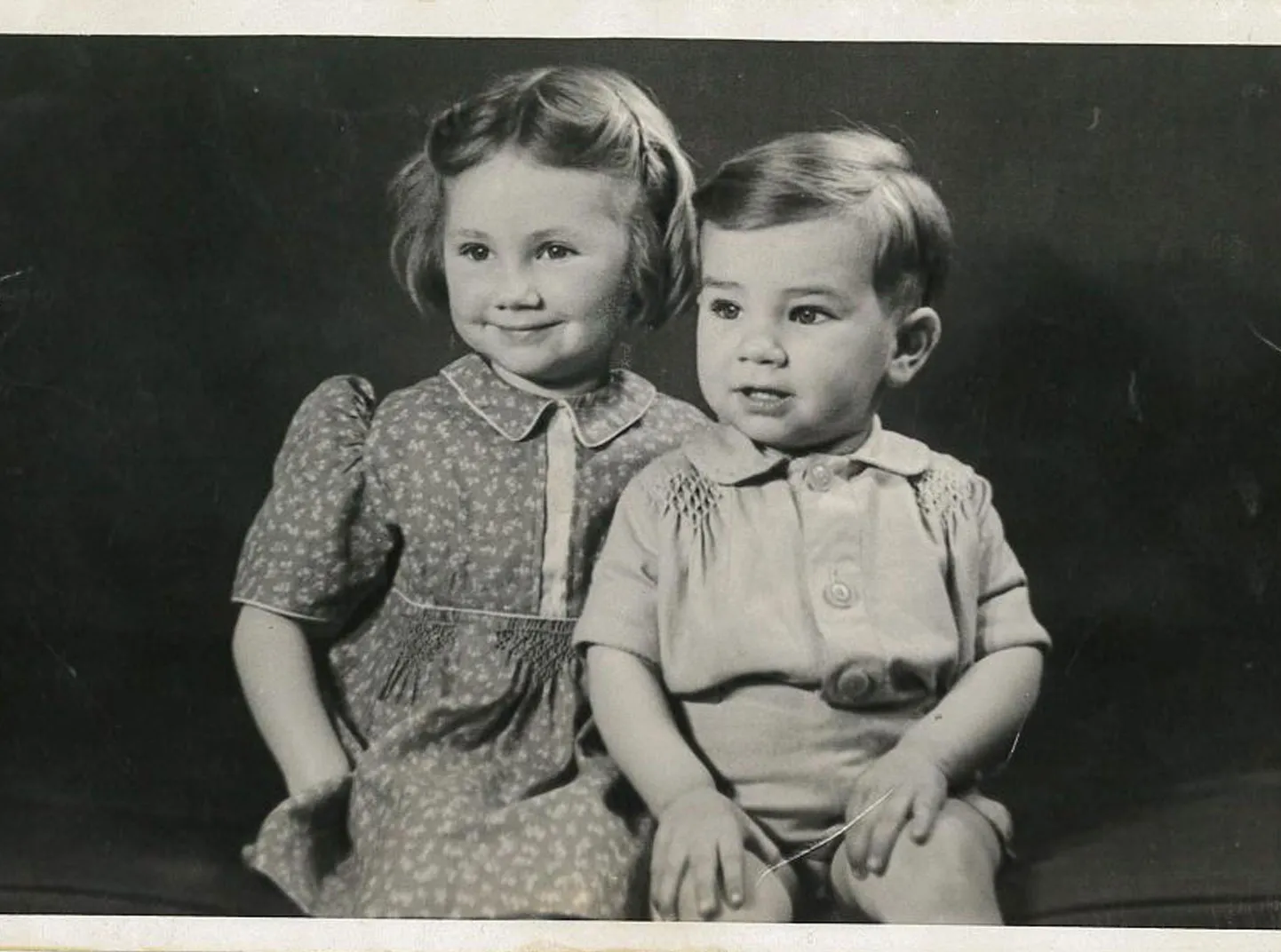 A black and white image of a young boy and girl.
