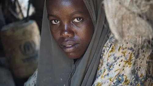 Eleven-year-old Safiyo sits in her home in Dadaab refugee camp, one of the largest refugee camps in the world.