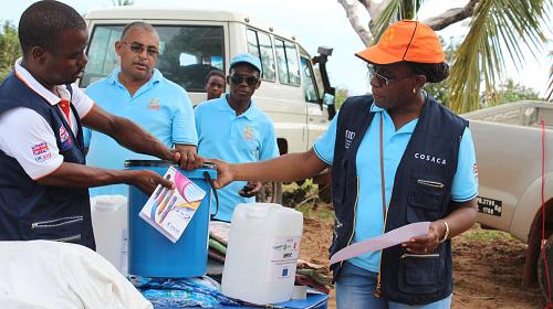CARE staff distributing emergency kits in the district of Massinga, Mozambique. Cyclone Dineo tore through the coast of Mozambique destroying houses, schools, health centres and other infrastructure. The cyclone also demolished crops of maize and ground nuts, the first harvest after a prolonged drought. CARE is working with the government to assist communities by providing emergency household items such as a tarpaulin, blankets, buckets, ground sheets and mosquito nets. Photo credit: Aderito Bie/CARE