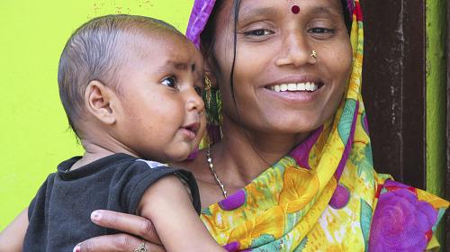 Vinita, age 28, stands outside her home with her healthy baby. CARE’s Bihar technical Support Program, is helping Vinita and her likes to take world-class accepted home based care of herself and her baby with the available resources. CARE 