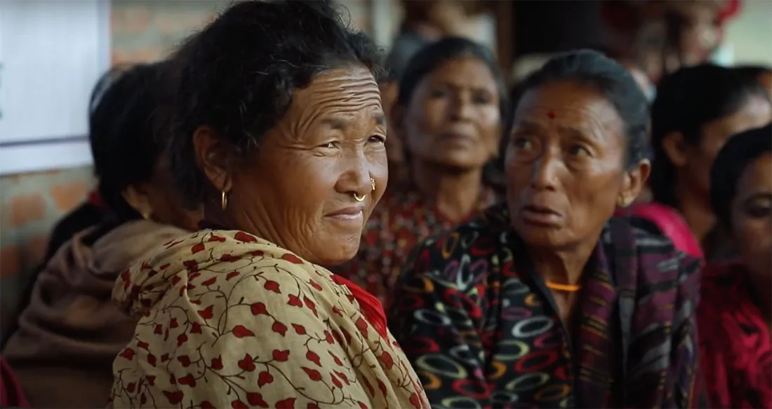 Una mujer de mediana edad en un grupo de mujeres nepalesas.