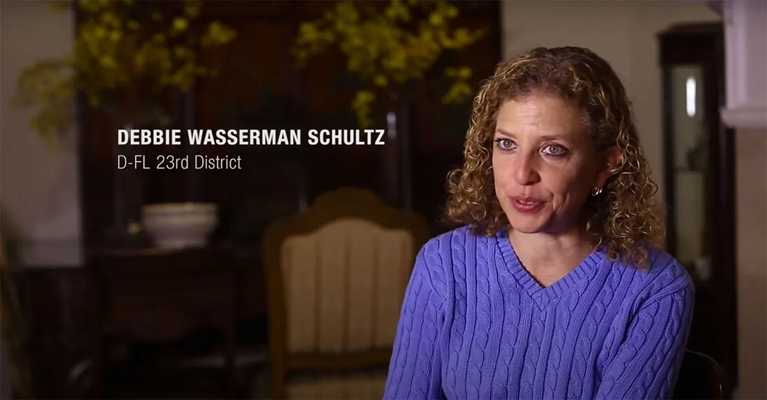 Rep. Debbie Wasserman Schultz sits down in a room for an interview.