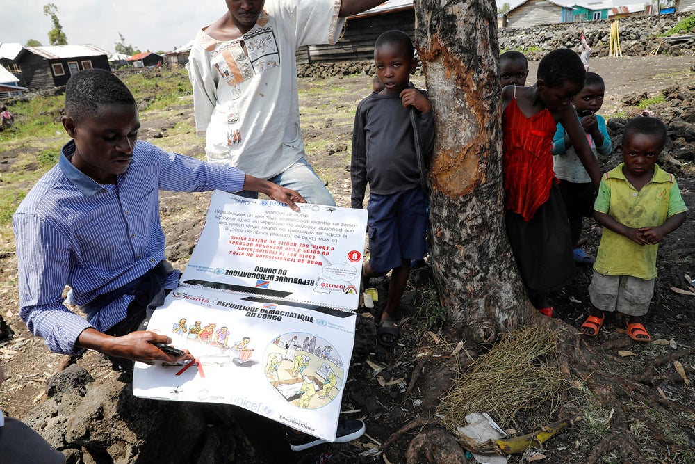 Congolese volunteer Ferdinand Tangenyi displays a flip book he uses to inform people about Ebola in the eastern city of Goma.