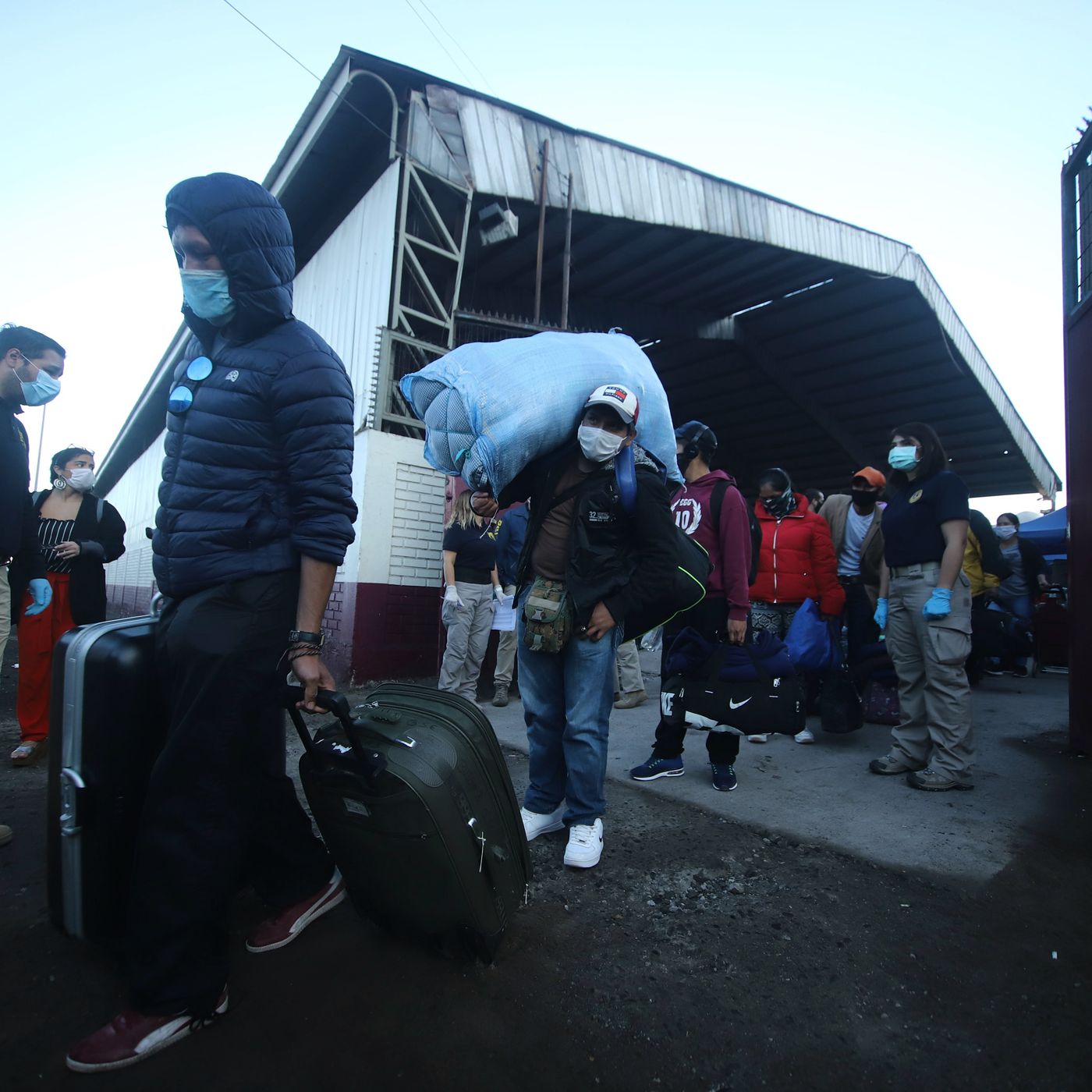 Bolivians stranded in Chile due to the novel coronavirus Covid-19 lockdown are taken to the Bolivian border to cross into their country, in Iquique, on April 20. Ignacio Muñoz/AFP via Getty Images