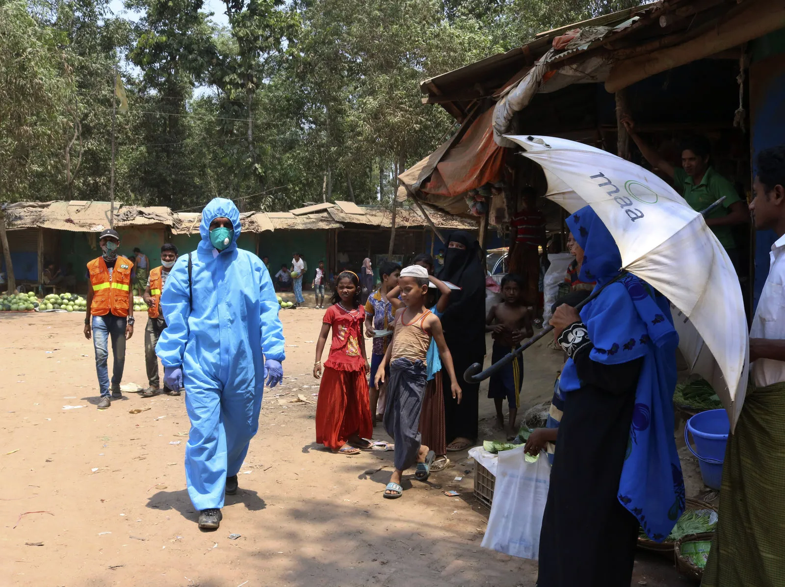 A health worker wearing personal protective equipment in the Kutupalong Rohingya refugee camp in Cox's Bazar, Bangladesh, last month. On Thursday, Bangladesh reported the area's first confirmed coronavirus infections. Shafiqur Rahman/AP