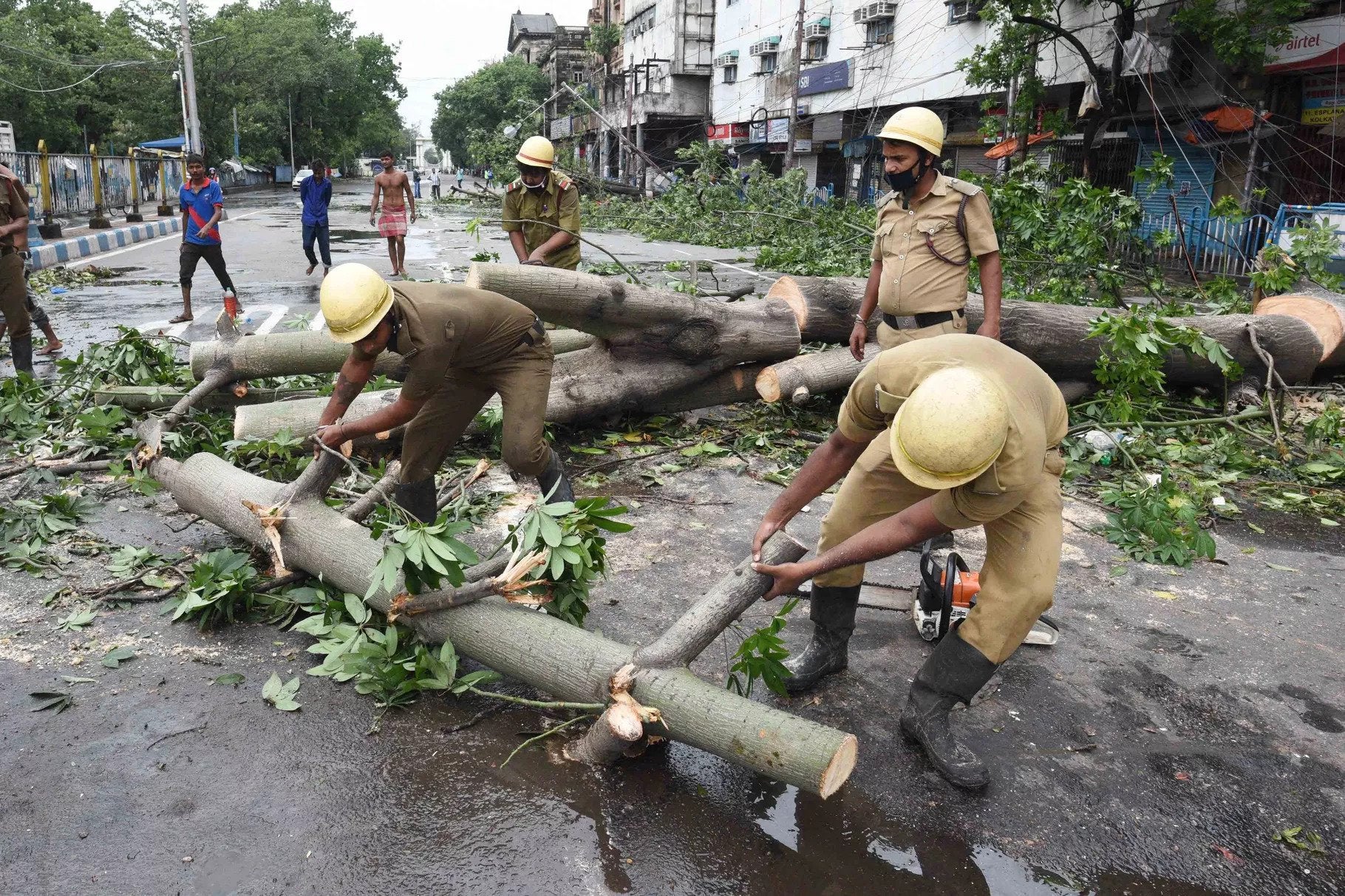 Disaster management teams clear the streets of uprooted trees at Esplanade after Cyclone Amphan on May 21, 2020, in Calcutta, India. Samir Jana/Hindustan Times via Getty Images