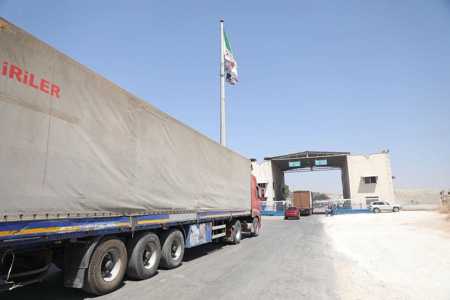 nternational humanitarian aid trucks cross into Syria at a crossing on the Turkish border on Thursday. (EPA-EFE/Shutterstock)