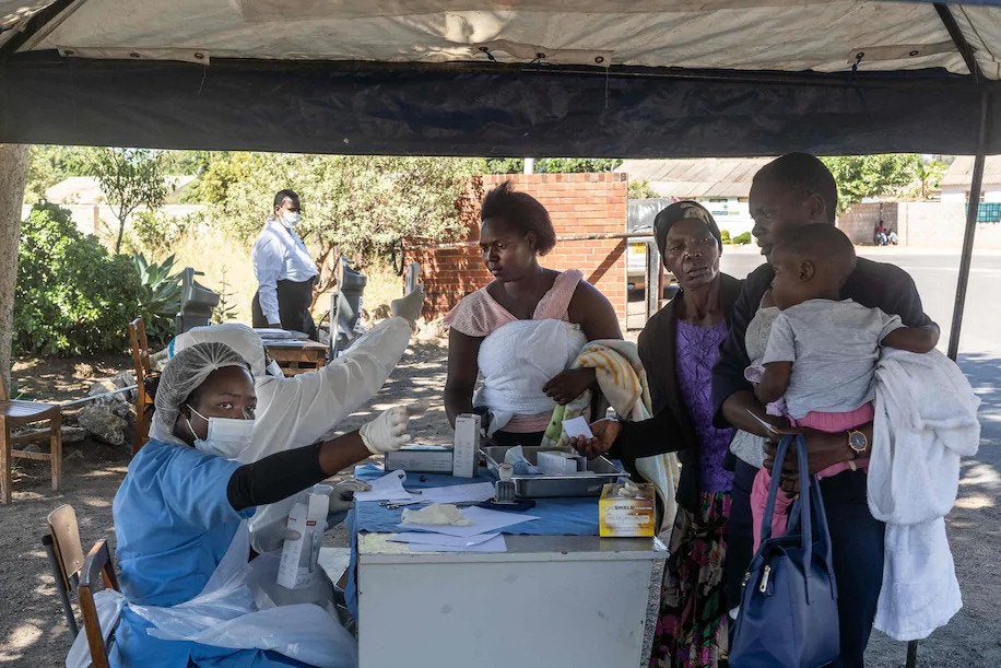 Health-care workers check the temperature of patients visiting the Mpilo Hospital in Bulawayo, Zimbabwe, on April 25. (Zinyange Auntony/AFP/Getty Images)