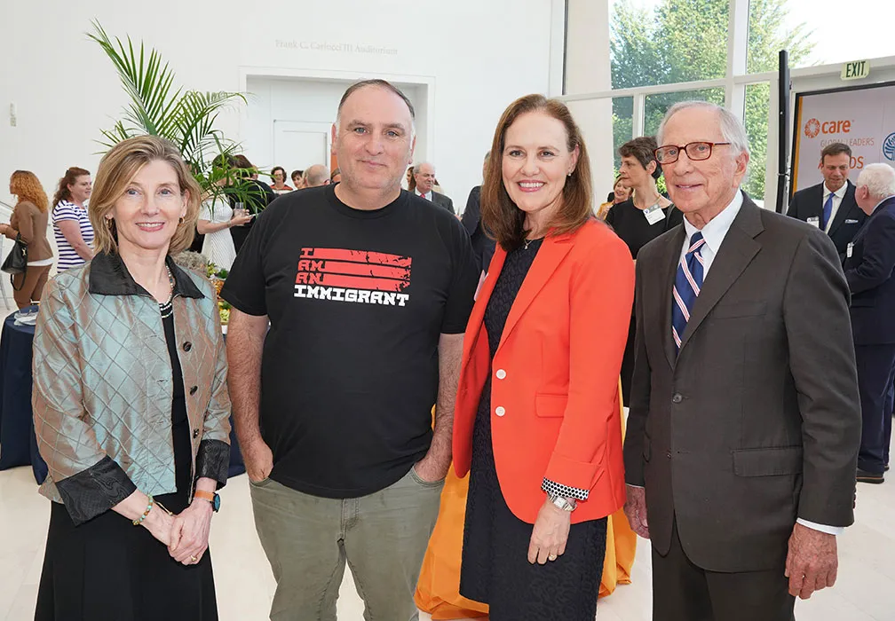 Michèle Flournoy, former U.S. Undersecretary of Defense for Policy, and chef José Andrés stand with two attendees at the Global Leaders Network Awards Reception. José Andrés wears a t-shirt that says, 