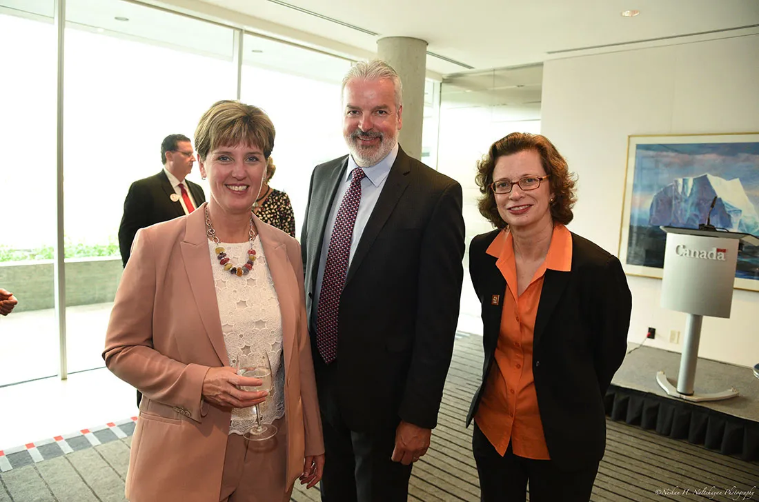 CARE CEO Michelle Nunn stands for a photo with a man and woman.
