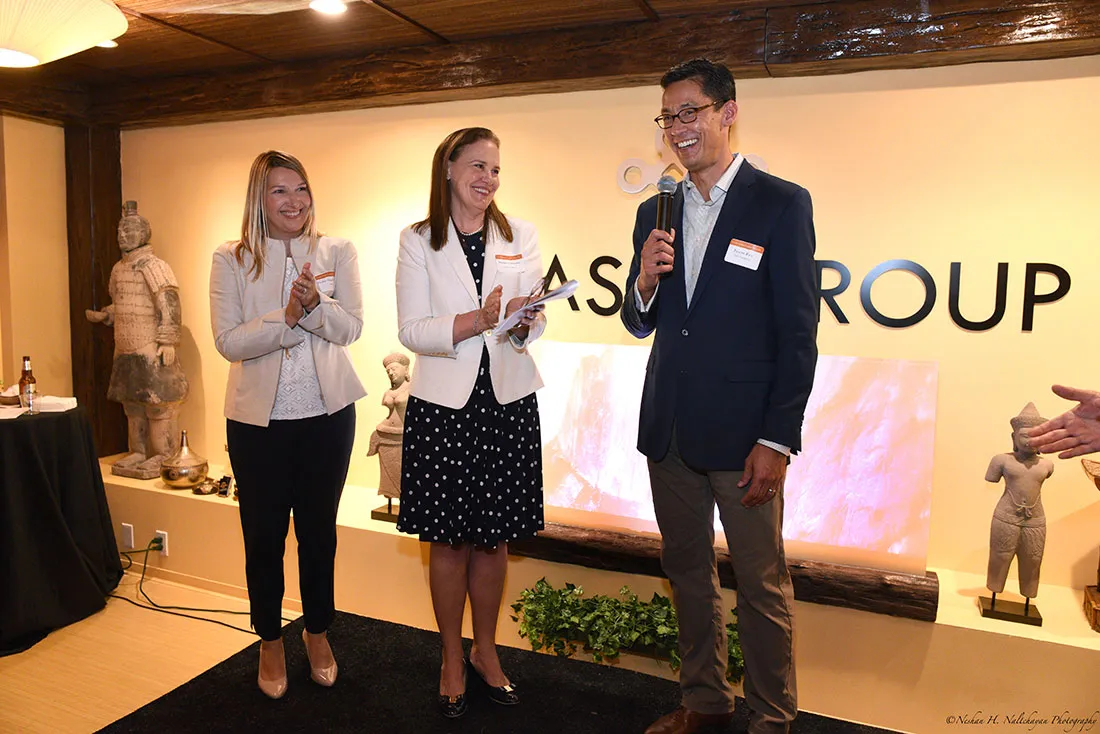 Former Under Secretary Michéle Flournoy and former CARE COO Heather Higginbottom clap while Rexon Ryu, partner of The Asia Group, speaks to the crowd.