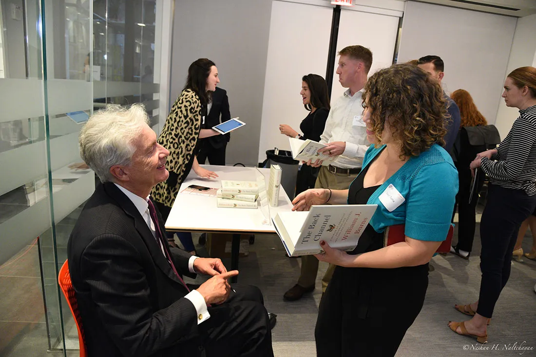 Ambassador William Burns speaks with a woman before signing a copy of his book, The Back Channel.