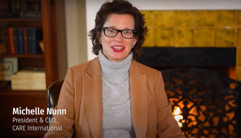 Michelle Nunn sitting in front of a fireplace.