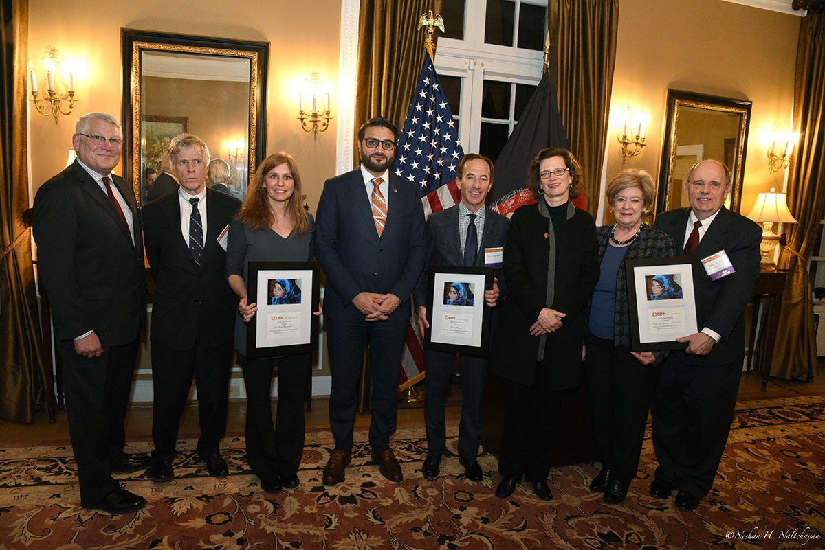 CARE CEO Michelle Nunn, Ambassador Hamdullah Mohib, Ambassador Ryan Crocker, and 5 other people stand together.