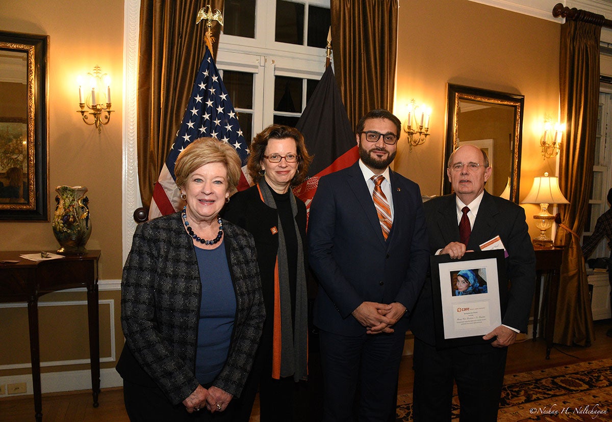 CARE CEO Michelle Nunn and Ambassador Hamdullah Mohib stand between a woman and a man holding a CARE award
