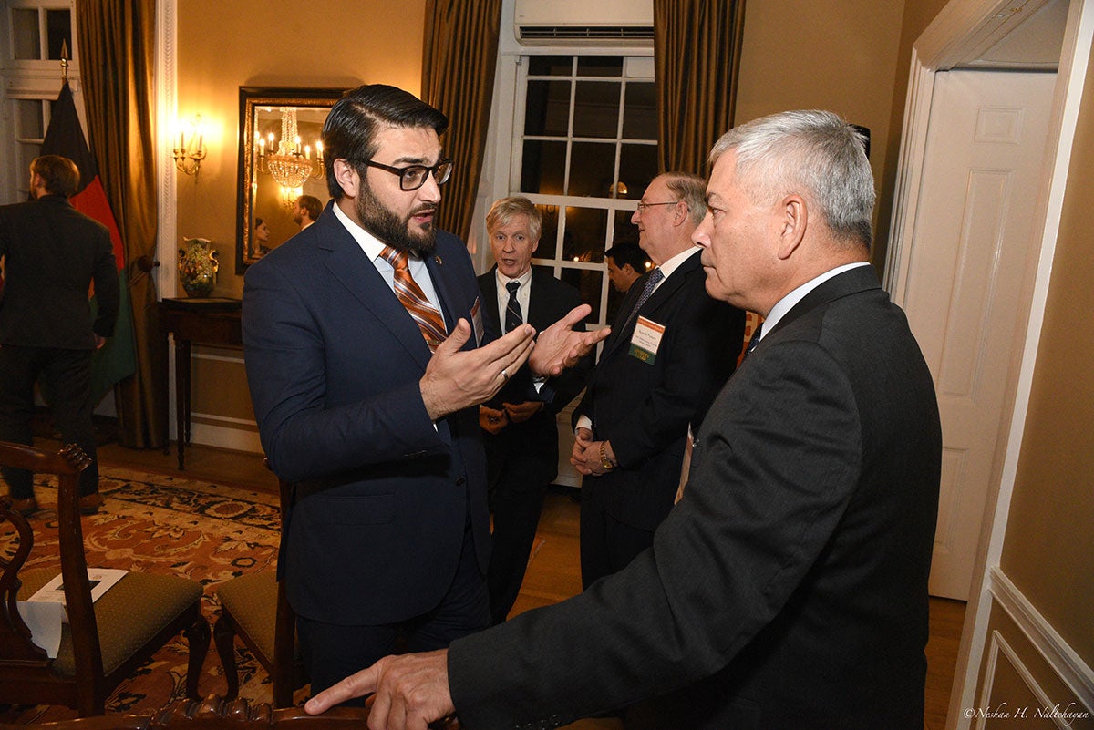 Ambassador Hamdullah Mohib is talking to a man in a black suit