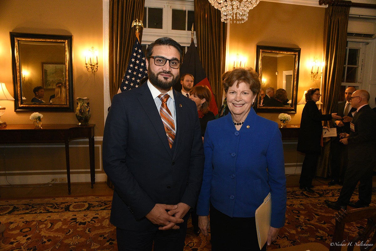 Ambassador Hamdullah Mohib stands next to a woman in a blue jacket