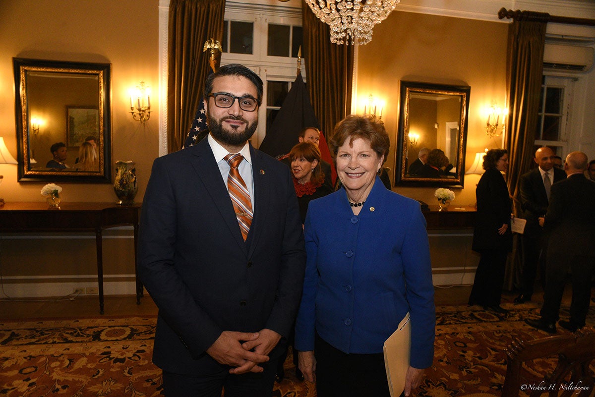 Ambassador Hamdullah Mohib stands next to a woman in a blue jacket
