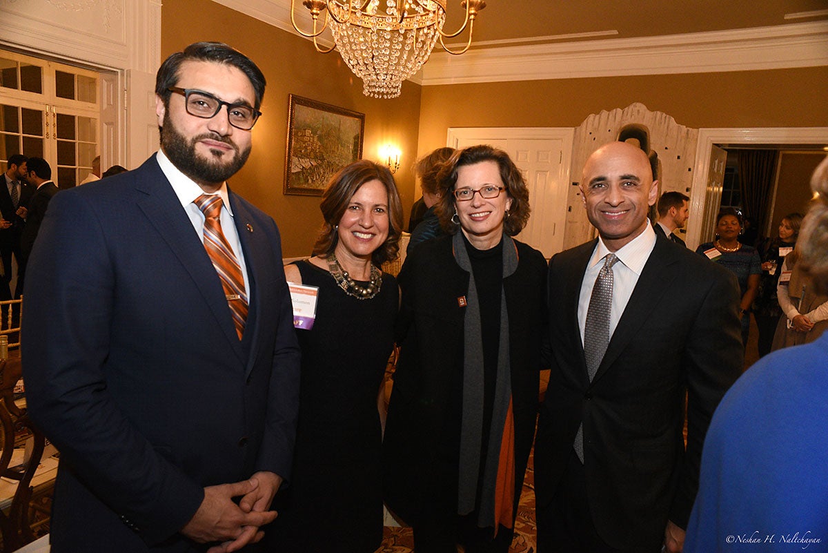 Ambassador Hamdullah Mohib and CARE CEO Michelle Nunn stand with a woman in a black dress and a man in a black suit