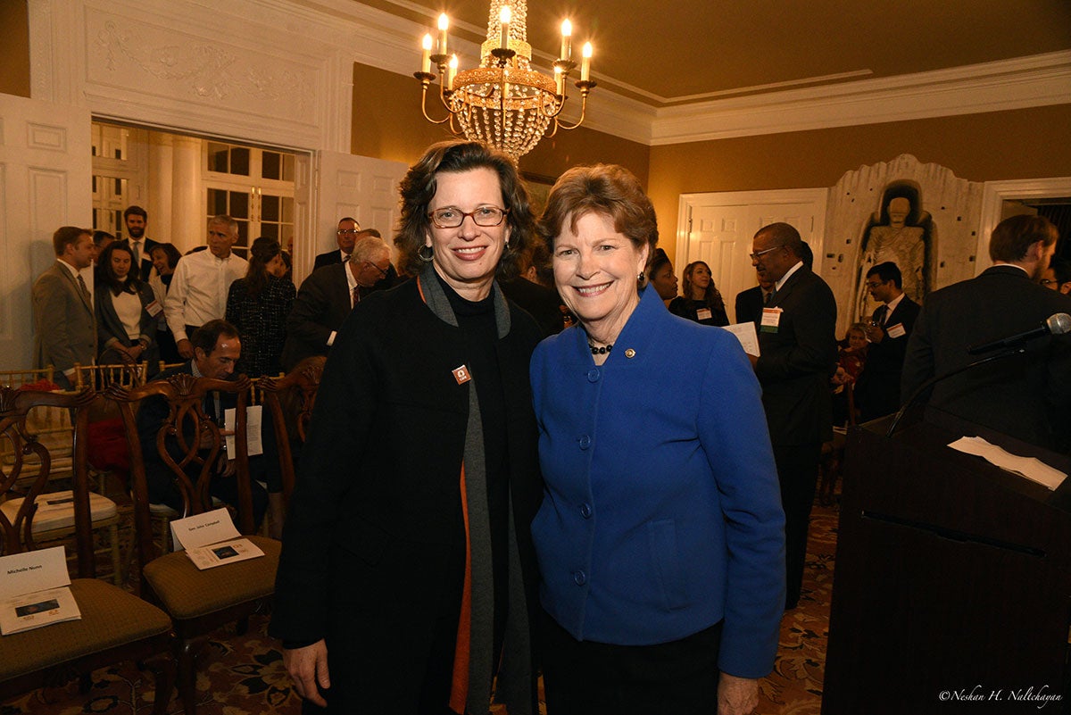 CARE CEO stands next to a woman in a blue jacket