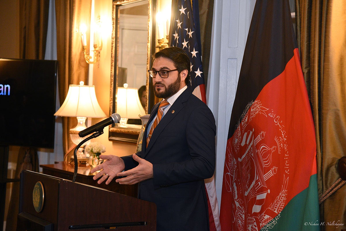Ambassador Hamdullah Mohib is holding a speech with both the American and Afghan flags in the background