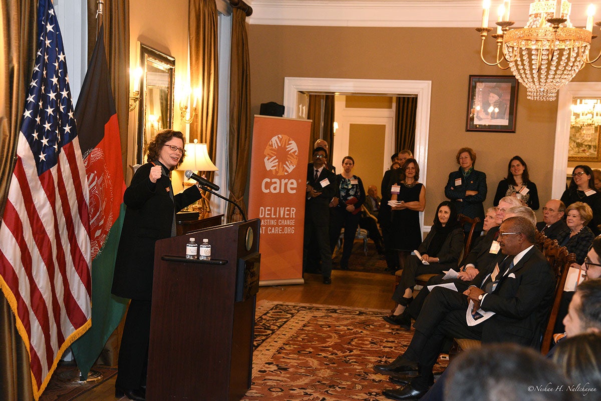 CARE CEO Michelle Nunn is holding a speech in a room in front all guests who are sitting on chairs
