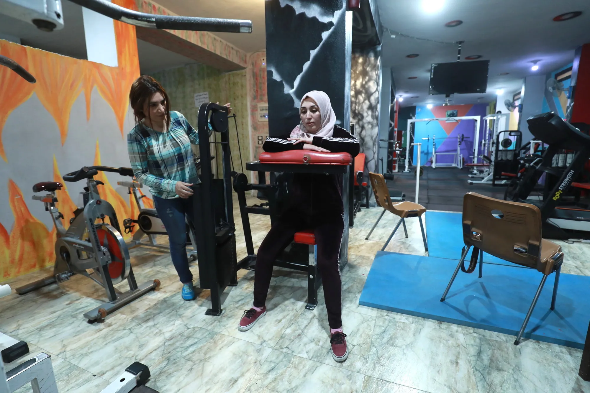 Woman exercises in a gym.