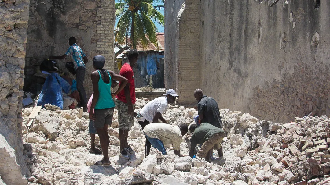A 7.2 magnitude earthquake hit Western Haiti on August 14, 2021, causing over 300 casualties. Here, a group of Haitian people dig through rubble.