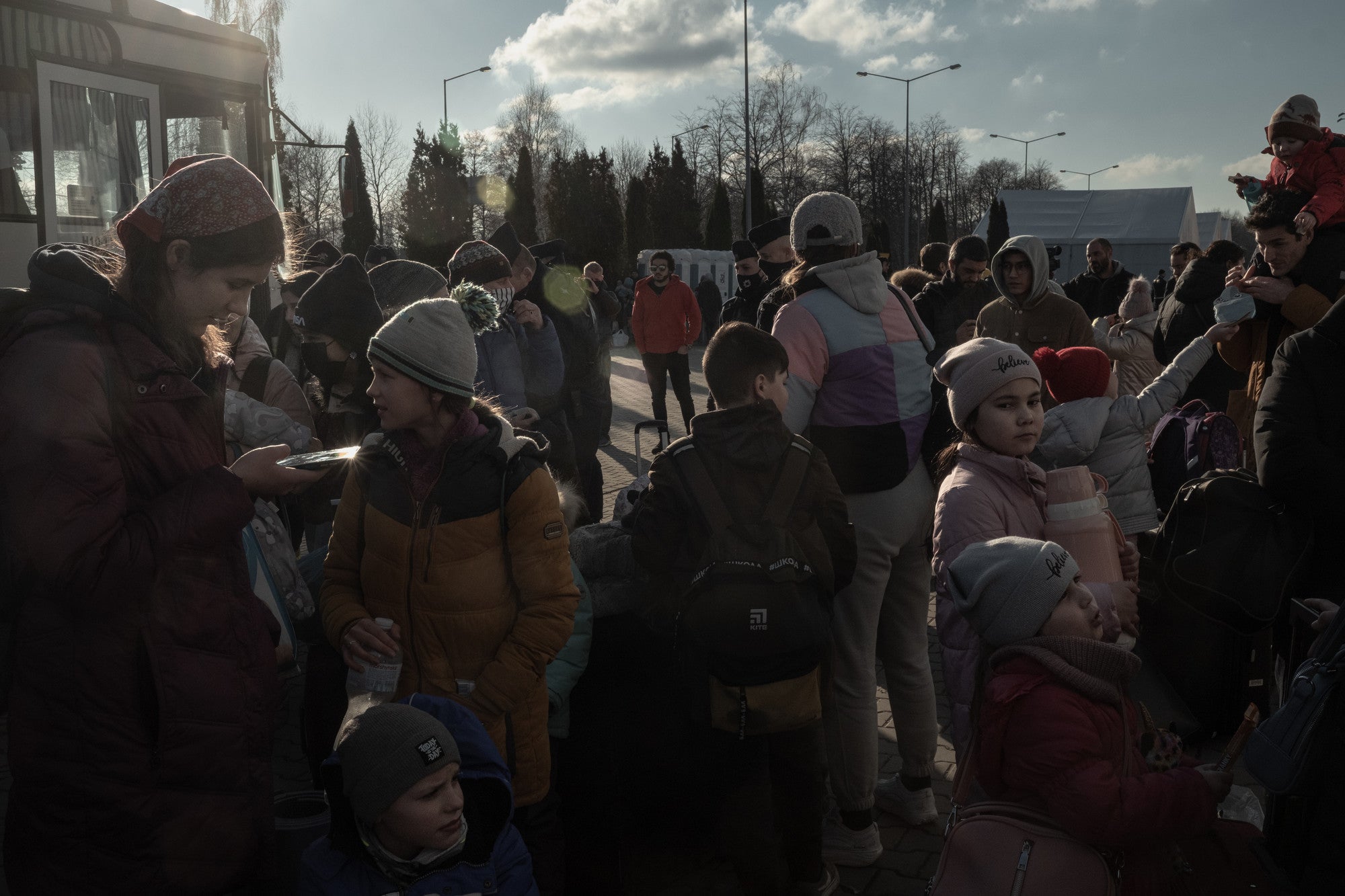Polish volunteers and authorities provide help for Ukrainian refugees as they arrive in Mlyny reception point with buses from the border crossing, in Przemsyl, eastern Poland.