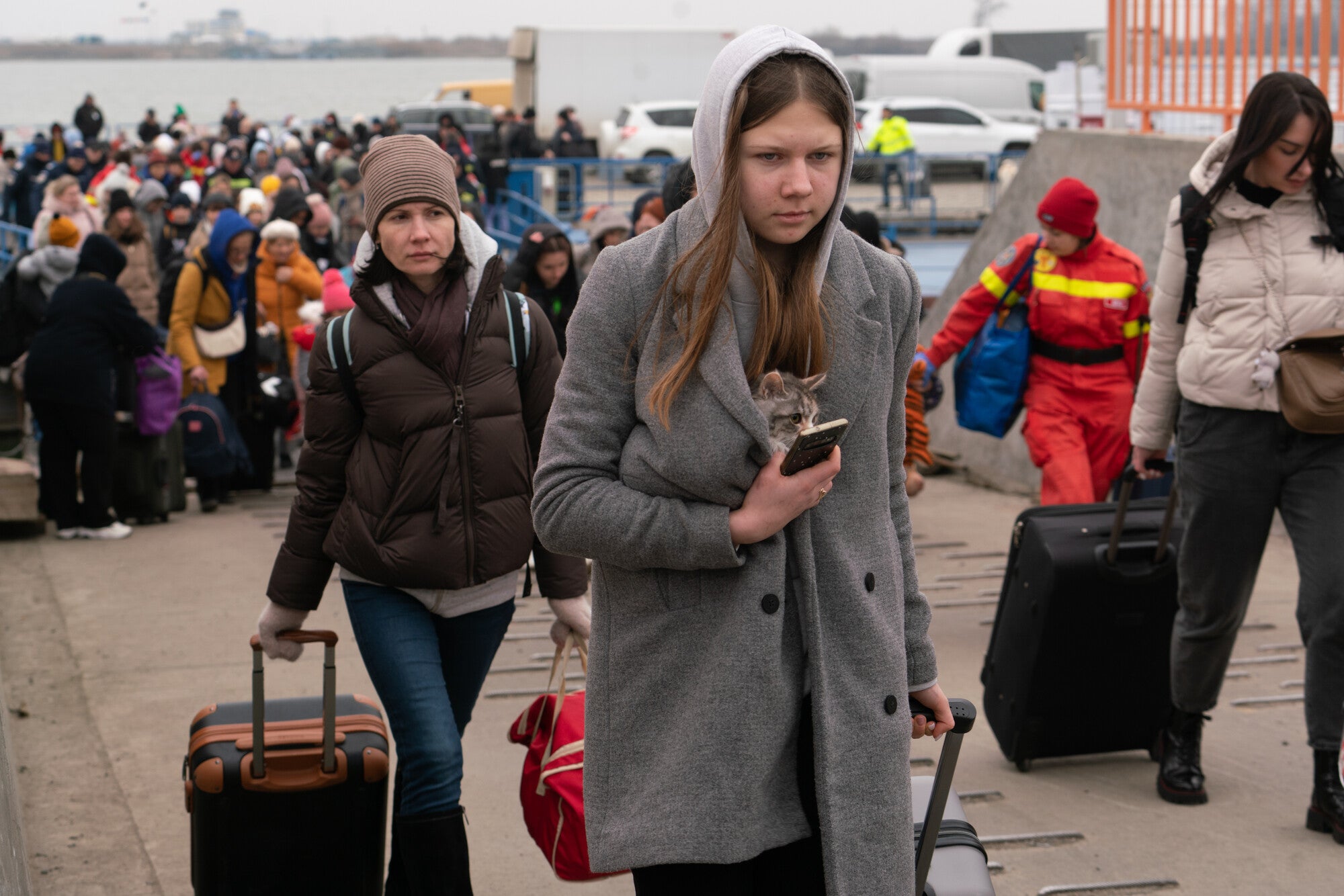 Newly arriving Ukrainians disembark the ferry across the Danube at Isaccea border crossing between Romania and Ukraine