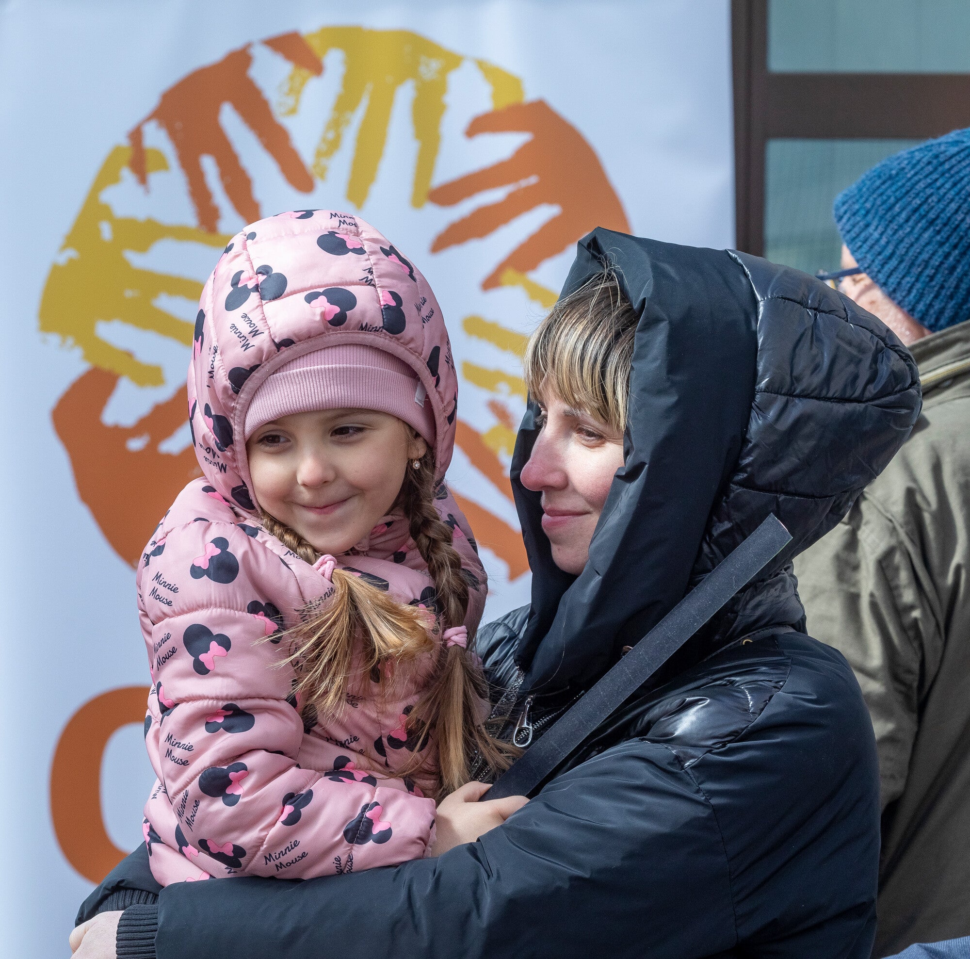 Ukrainian refugee Marina embraces her daughter, Arina, moments after passing through border control into Poland near the town of Hrebrenne.