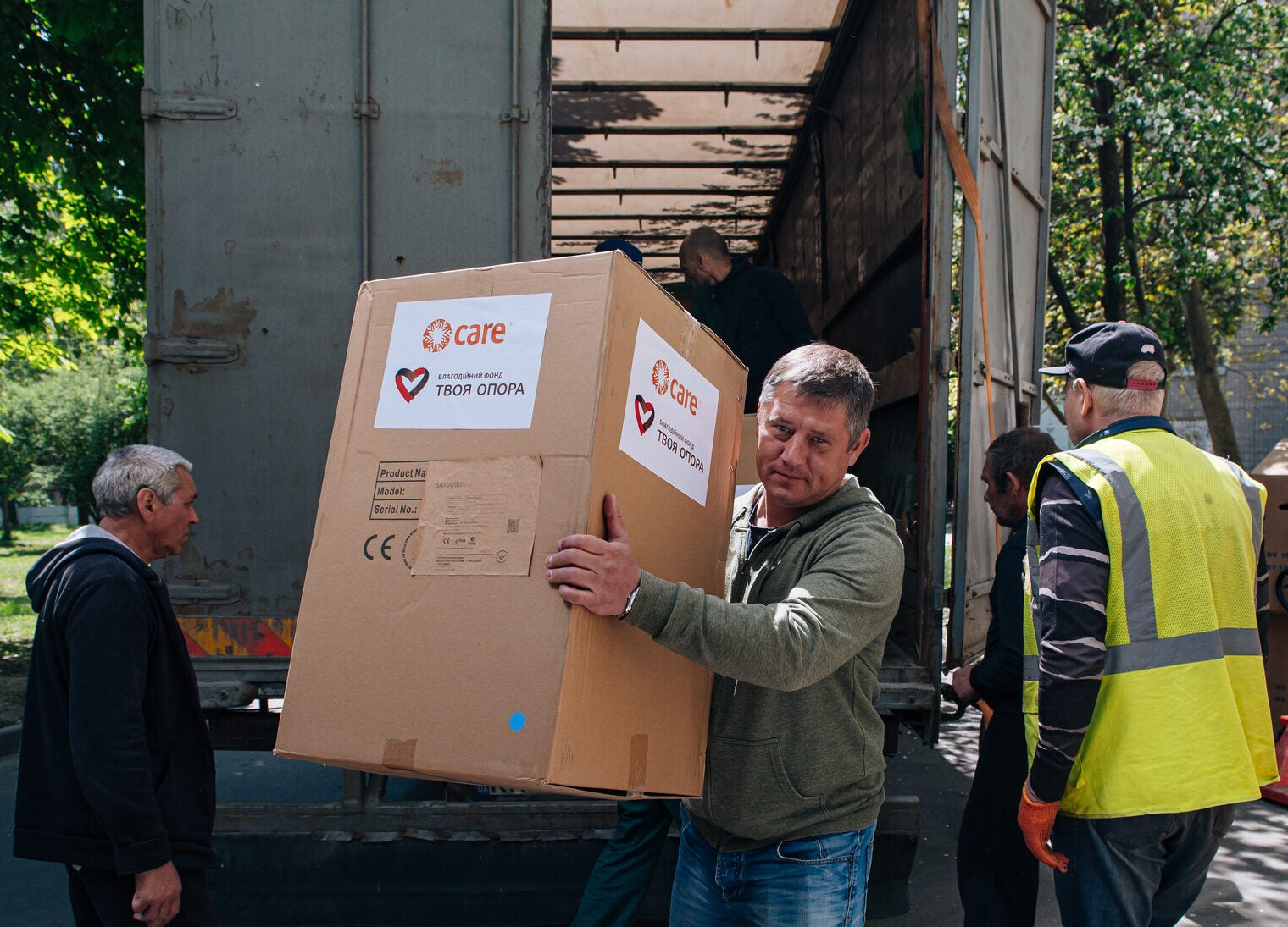 Image of man unloading a box from a truck