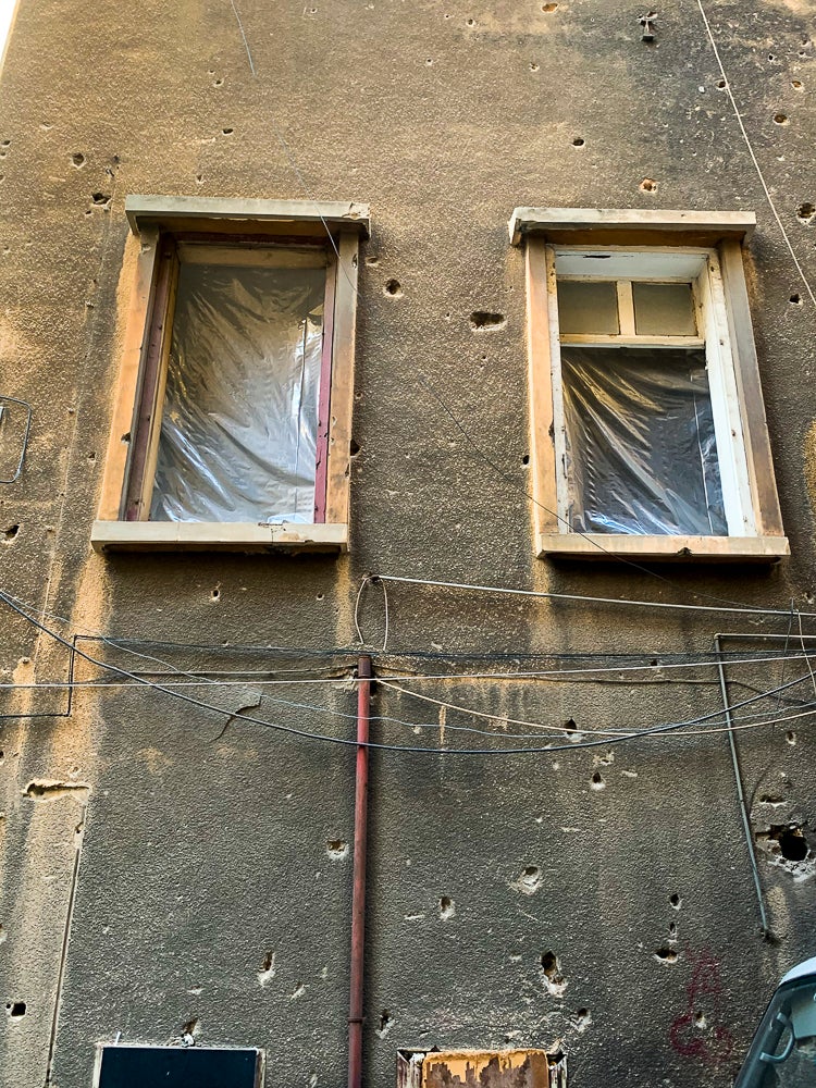 Detail image of windows with reconstructed frames and plastic sheeting