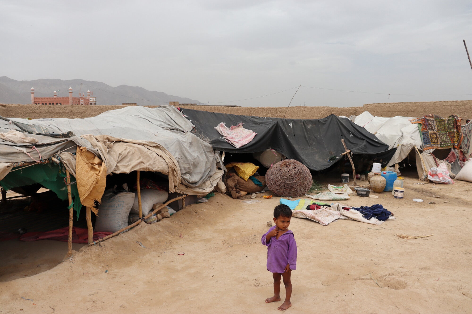 A child in front of a temporary shelter