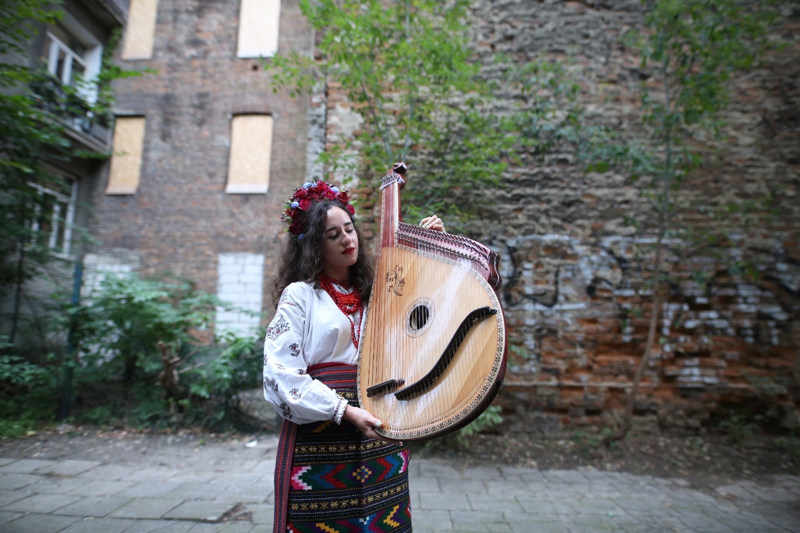 Woman in traditional dress holding a bandura
