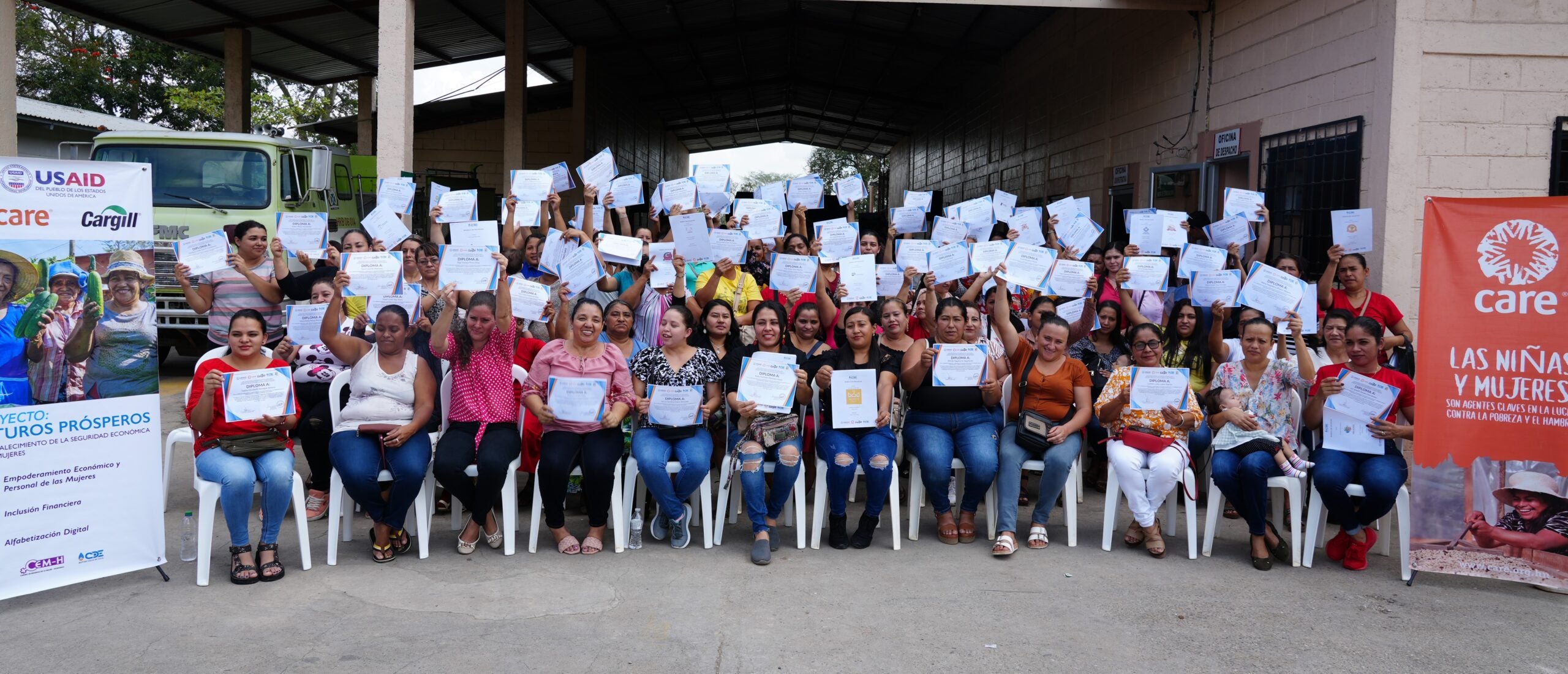 Group photo of women displaying graduation certificates