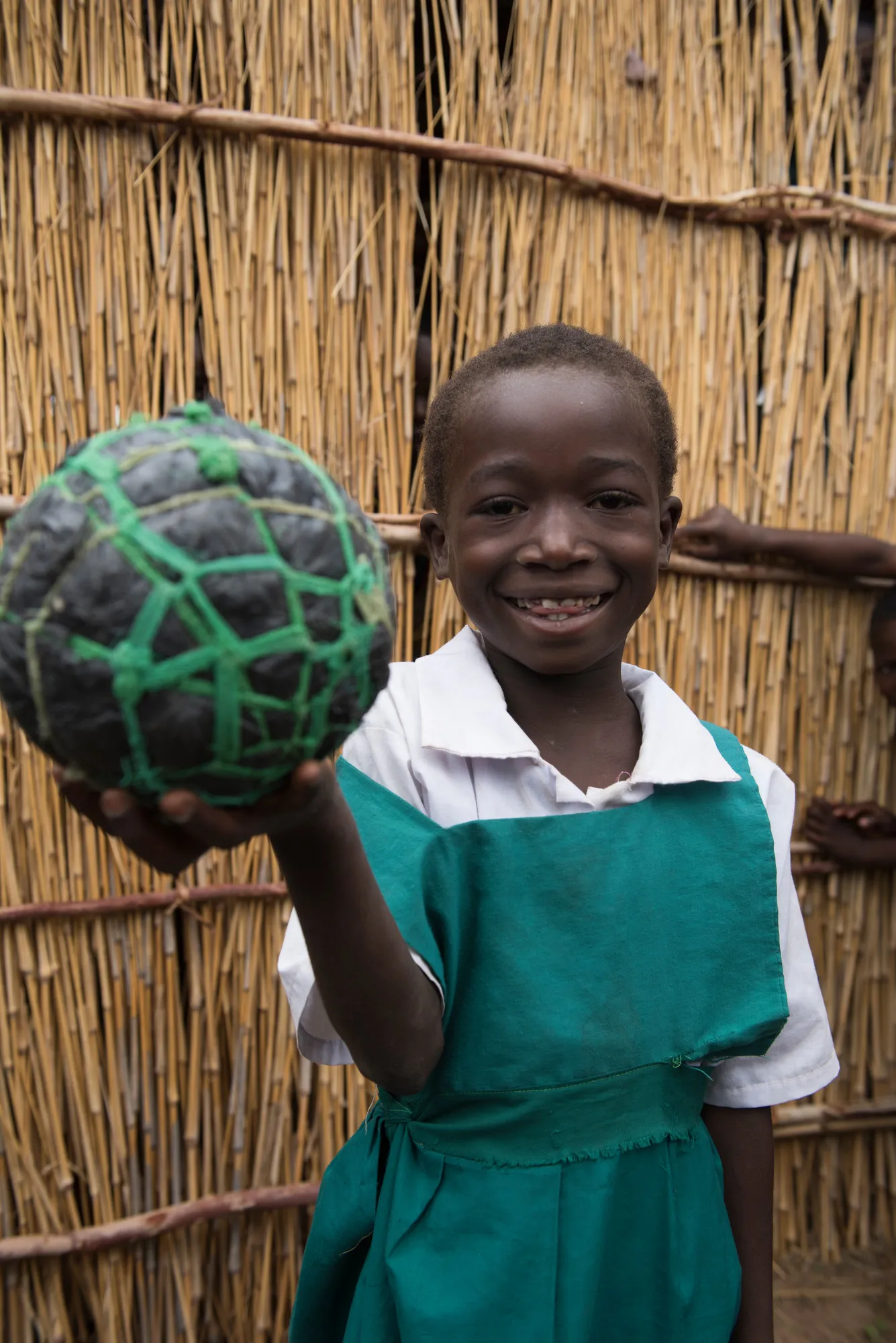 Portrait of young girl with makeshift soccer ball (football.)