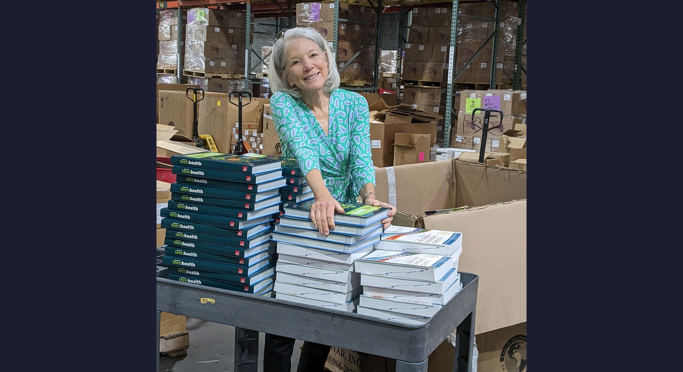 A CARE Women’s Network member organizing books for a Books for Africa event.