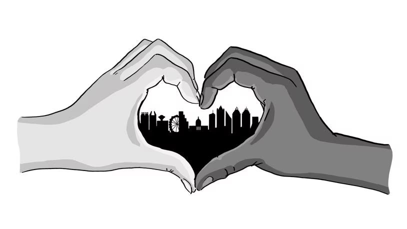Two hands forming a heart shape with a city skyline in the middle