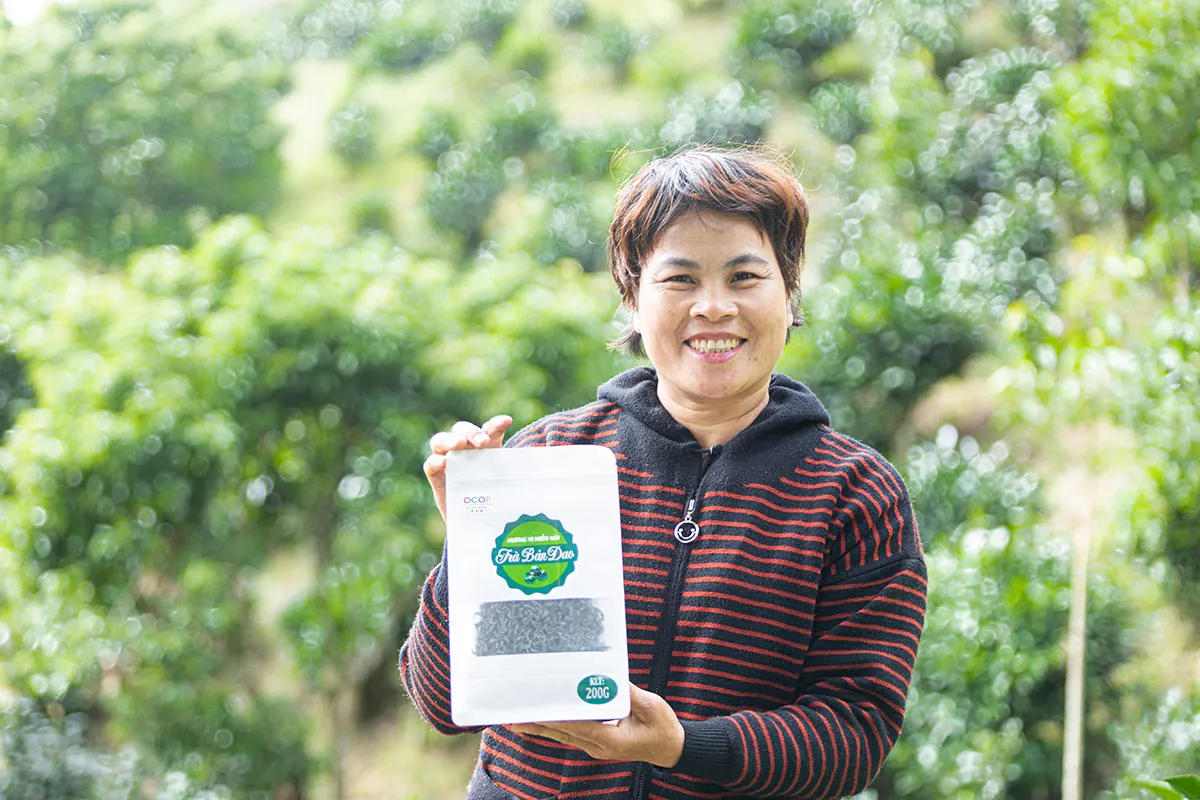 A Vietnamese woman holds up a food product.