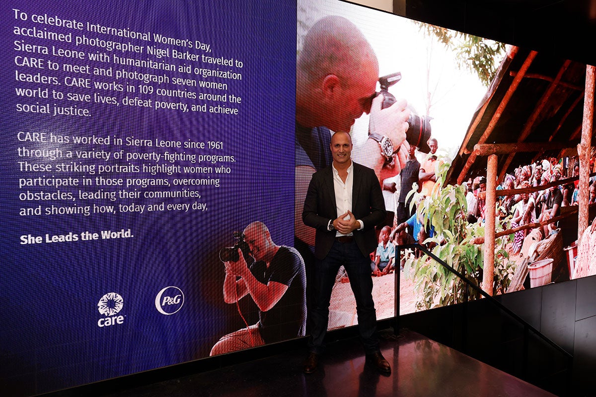 Nigel Barker stands in front of a photo he took as part of a partnership with CARE and P&G.