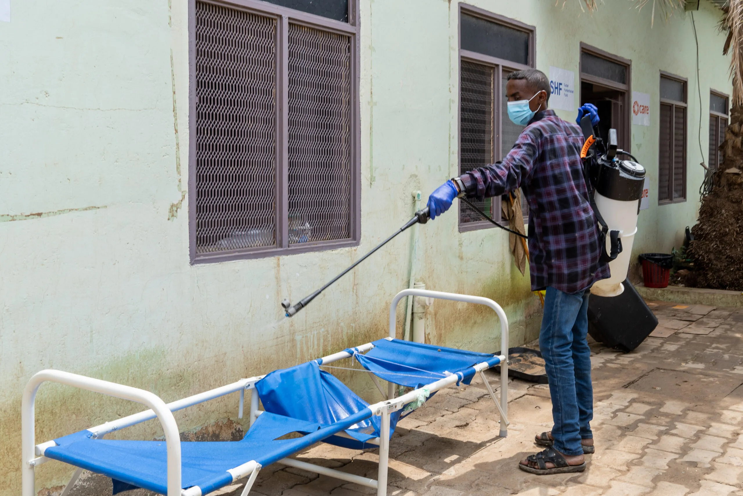 A person disinfecting a bed at a cholera treatment center