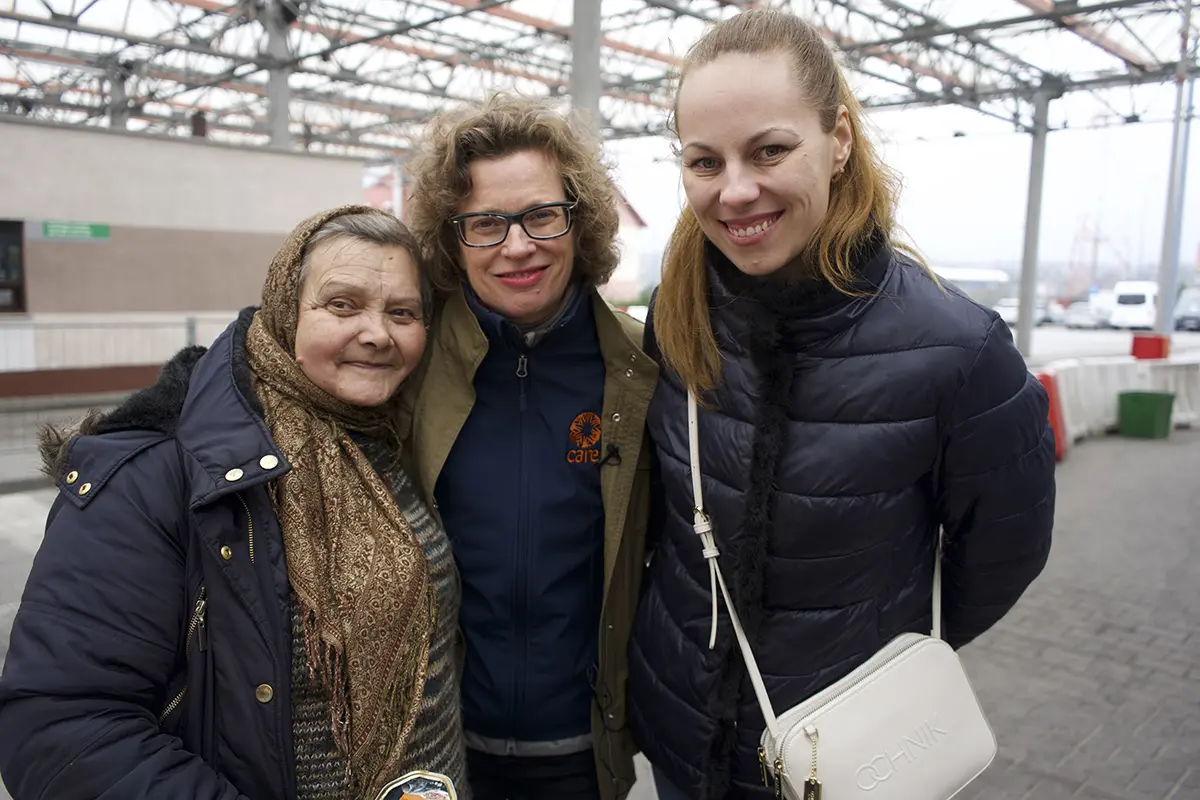CARE President and CE O Michelle Nunn smiles with two Ukrainian women.