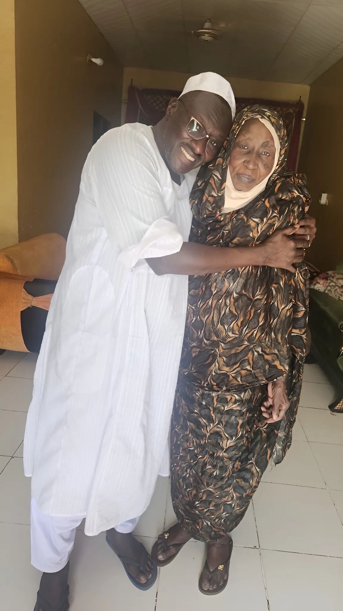 A CARE humanitarian embraces his mother in Sudan after three years apart.