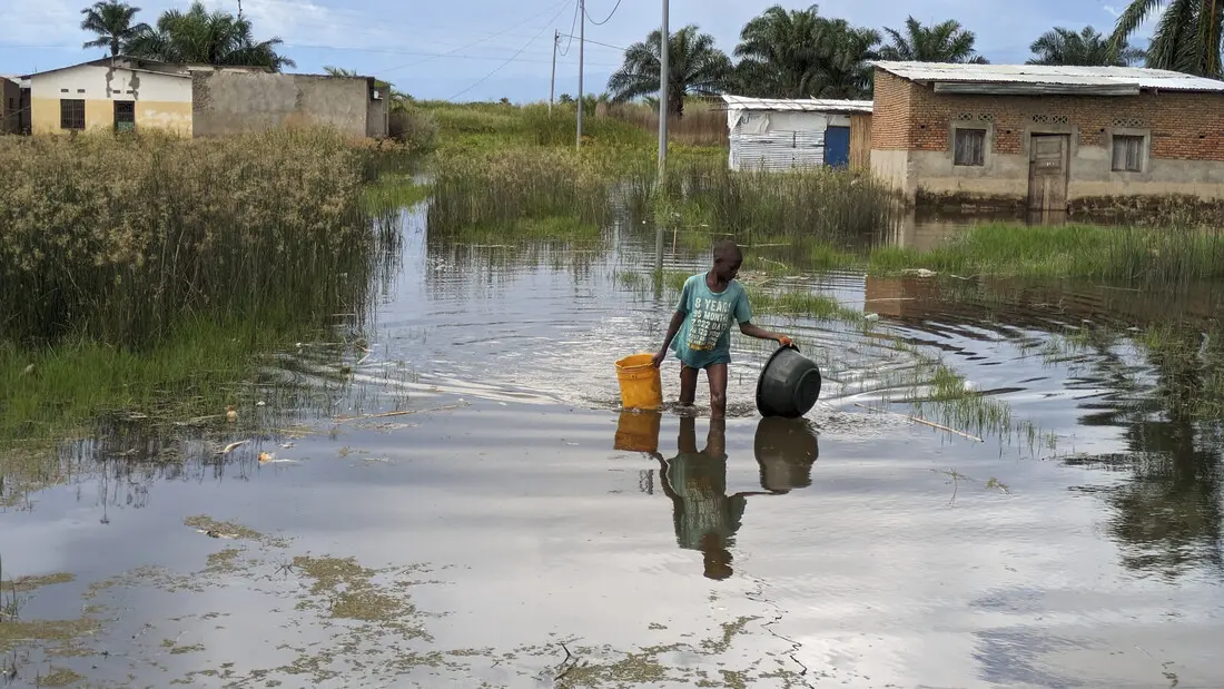 A boy walking through the flooded waters in Gatumba village.A boy walking through the flooded waters in Gatumba village.